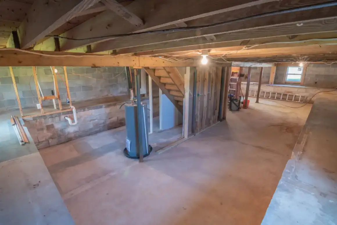 Unfinished Madison basement with block foundation walls and open joists before drywall work