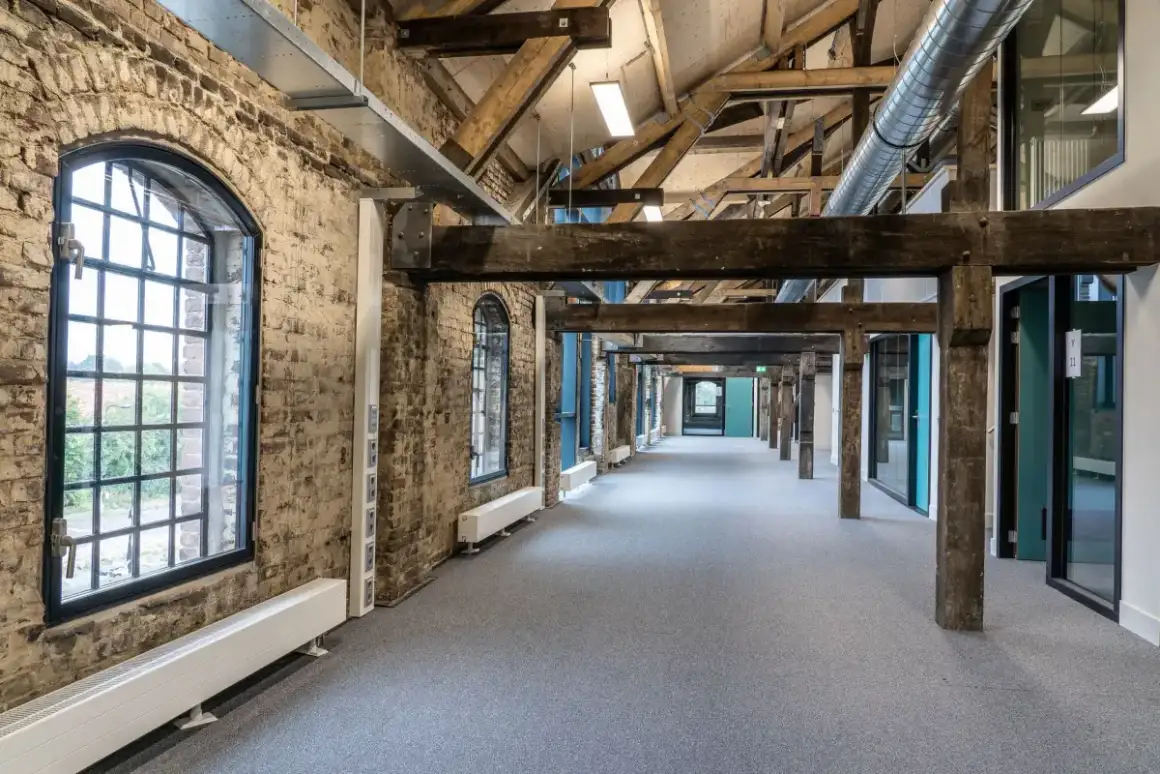 Commercial corridor with drywall walls of the kind that take repeated cart and equipment damage