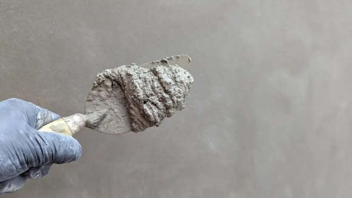 Close view of texture compound worked with a trowel, showing the grain the pattern carries