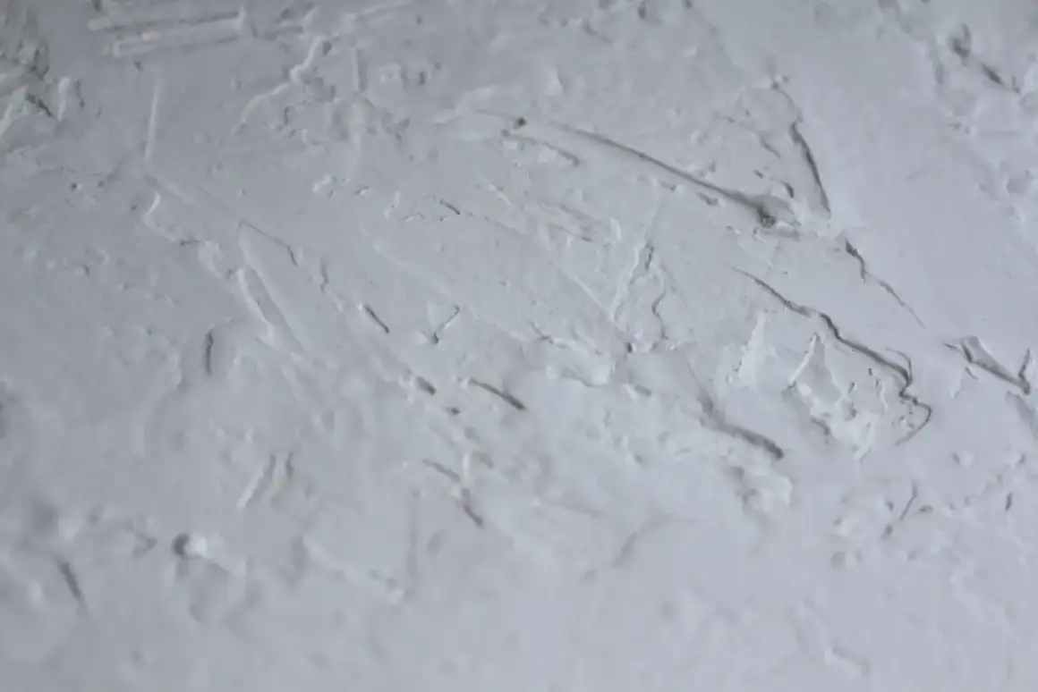 Textured popcorn ceiling surface before removal work begins in a Madison home