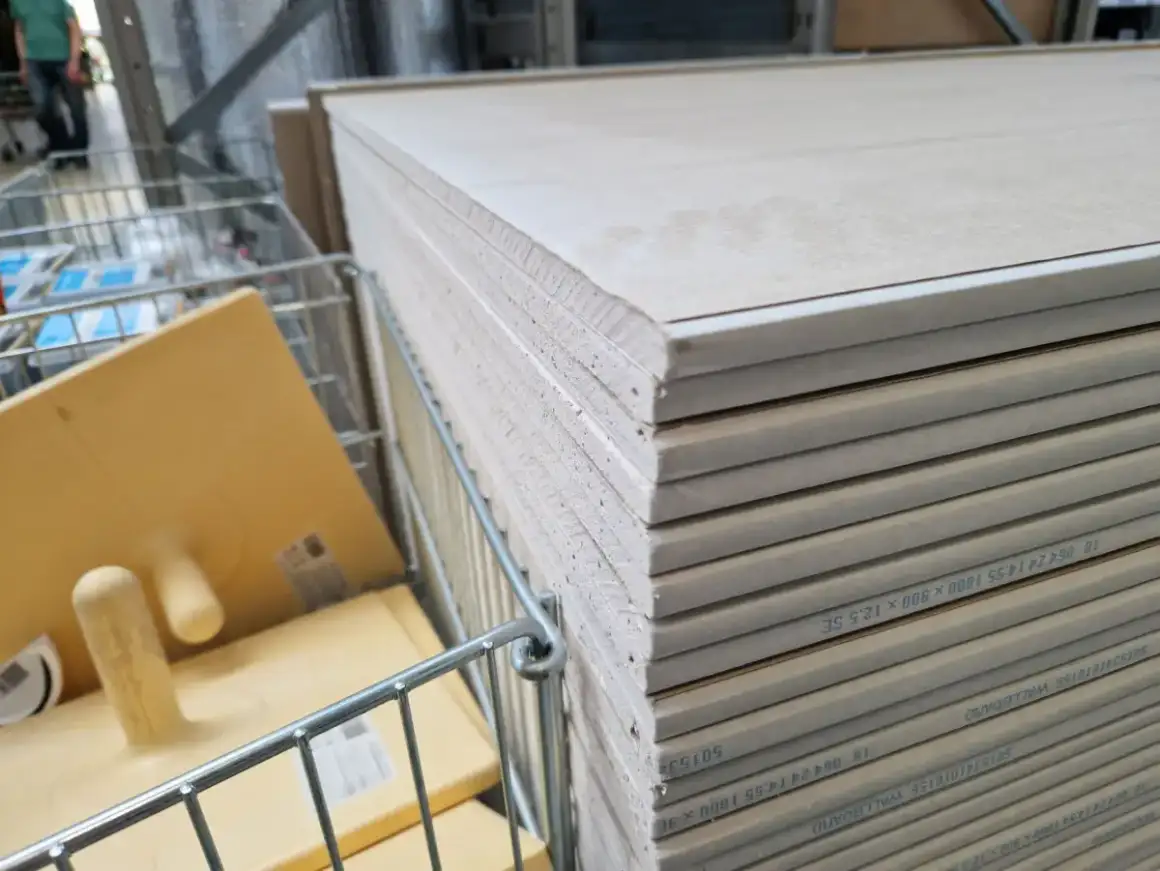 Drywall panels stacked on site for a tenant build-out